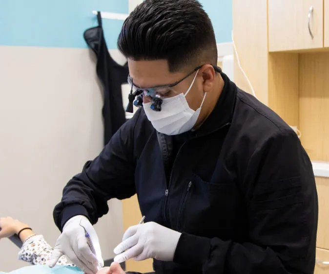 Emmanuel Cisneros of Independence, MO dental office True Dental Group examining a patient's teeth